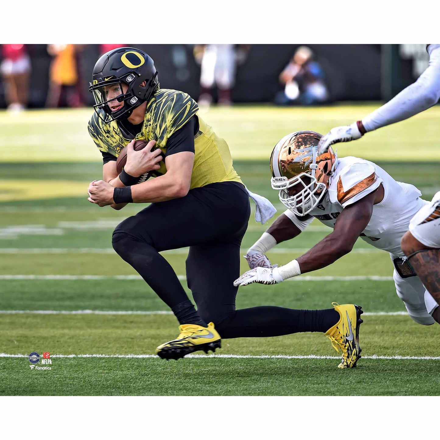 Justin Herbert Oregon Ducks Unsigned Yellow Jersey Running with Ball vs. Arizona State Photograph