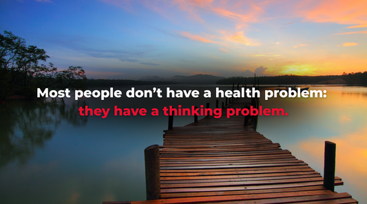 Peaceful wooden bridge extending over a calm lake at sunrise, with a quote overlay that reads: “Most people don’t have a health problem: they have a thinking problem.”