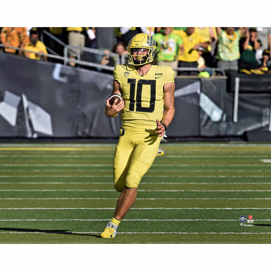 Justin Herbert Oregon Ducks Unsigned Yellow Jersey Running with Ball Photograph